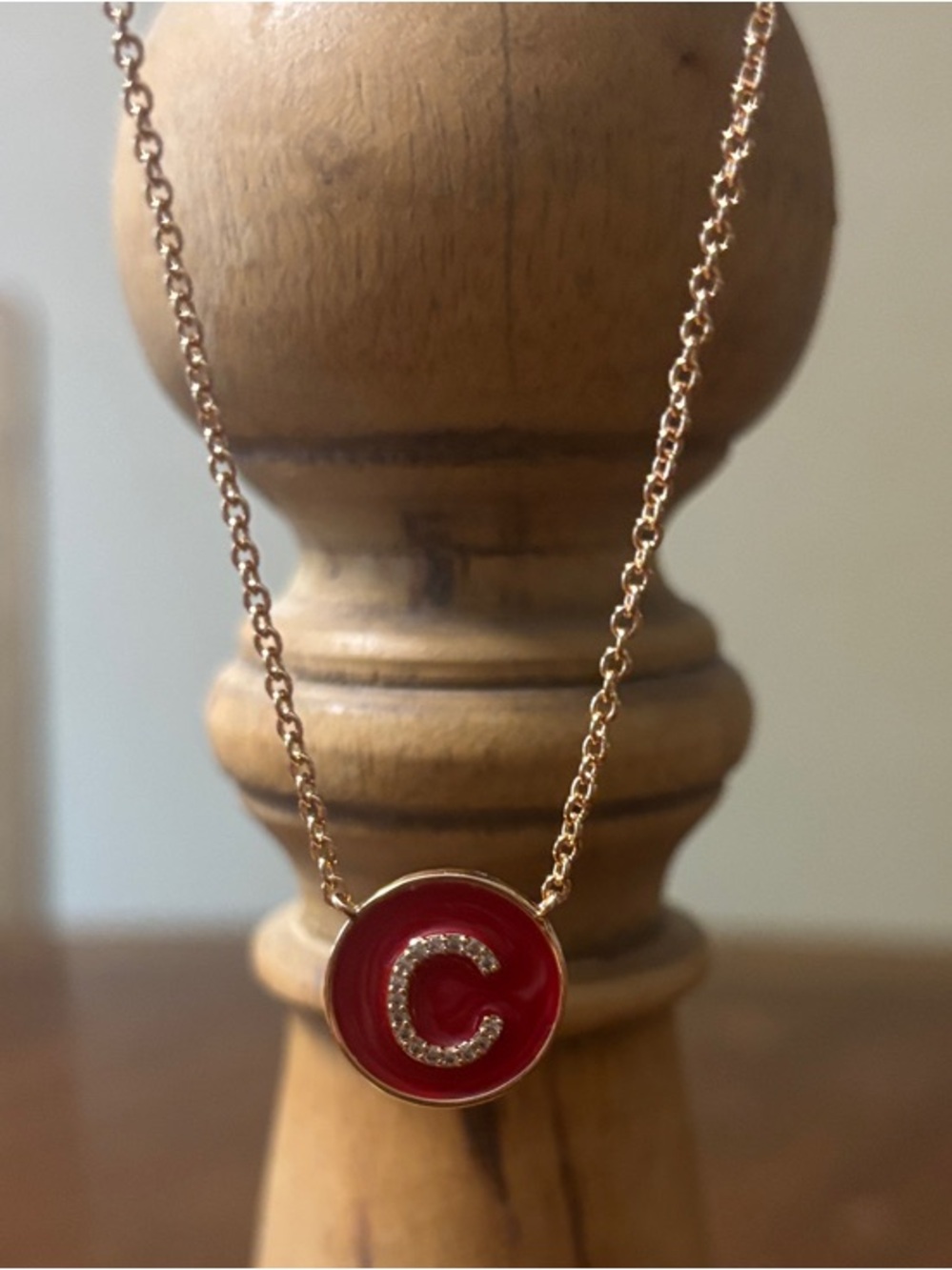 Gold-Tone Necklace with Red Enamel 'C' Pendant with cubic zirconia.